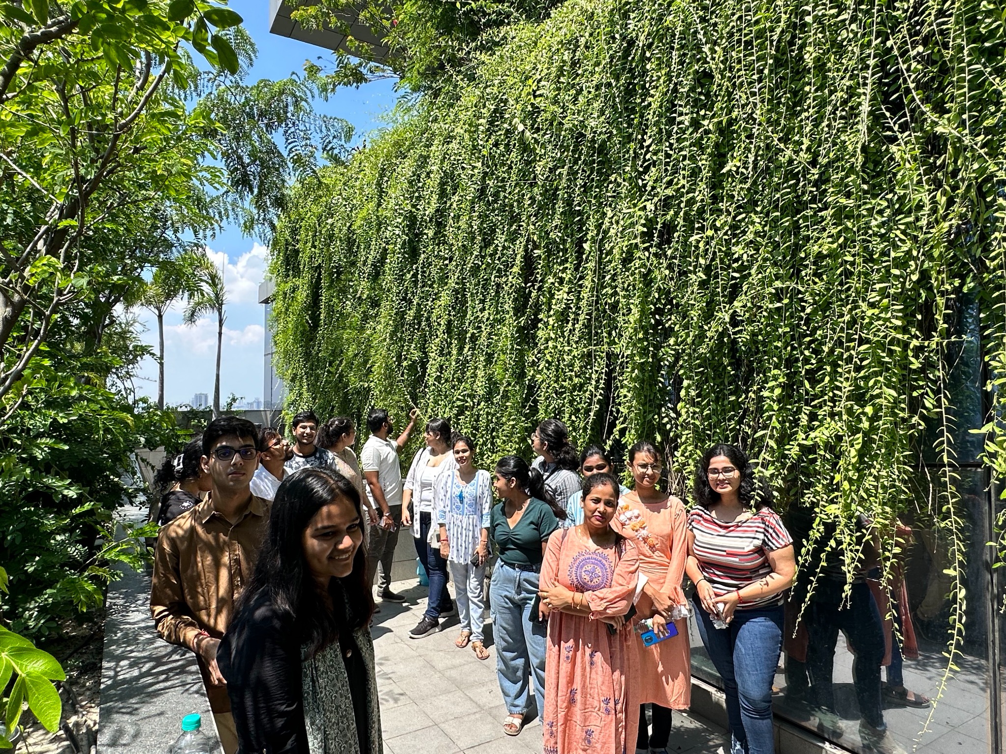 Visitors walking beside the living green screen at Biowonder, Kolkata